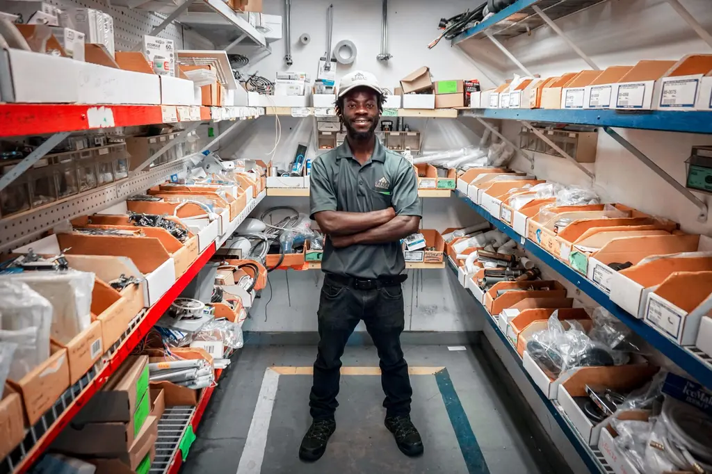 Moma Sayplay poses for a photo inside a supply room