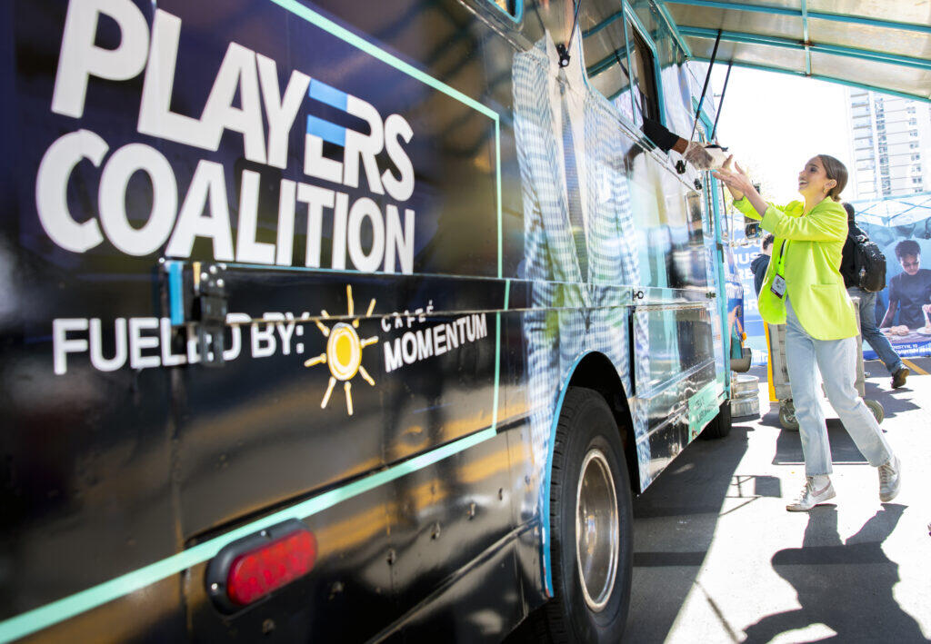 Woman receives food from the Players Coalition food truck