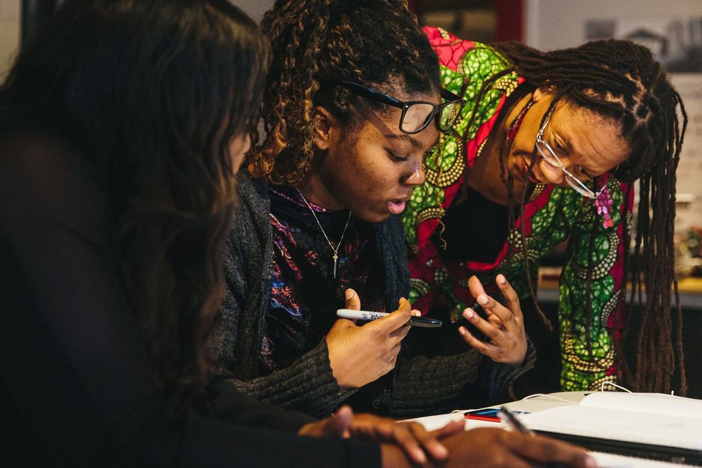 T. Paige Brown, Chicago Program Manager of i.c.stars helps interns with their work