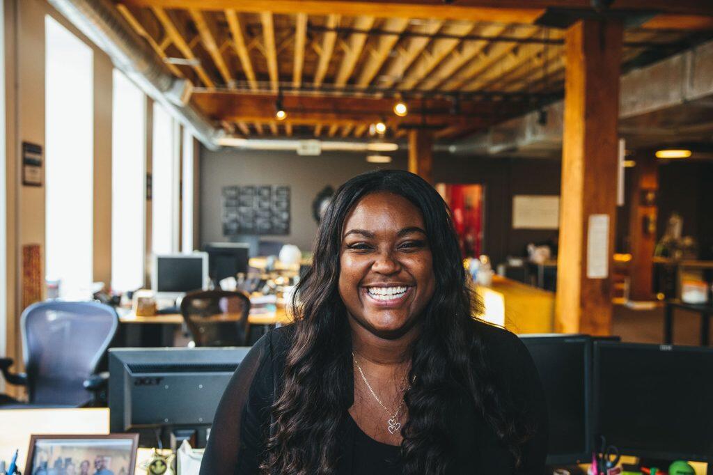 Tierra Phillips, i.c.stars intern poses for a photo in an office