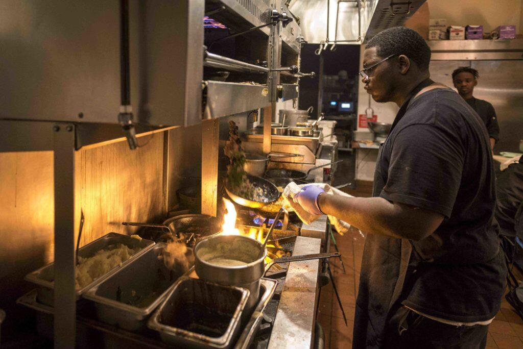 A young man cooking in a kitchen