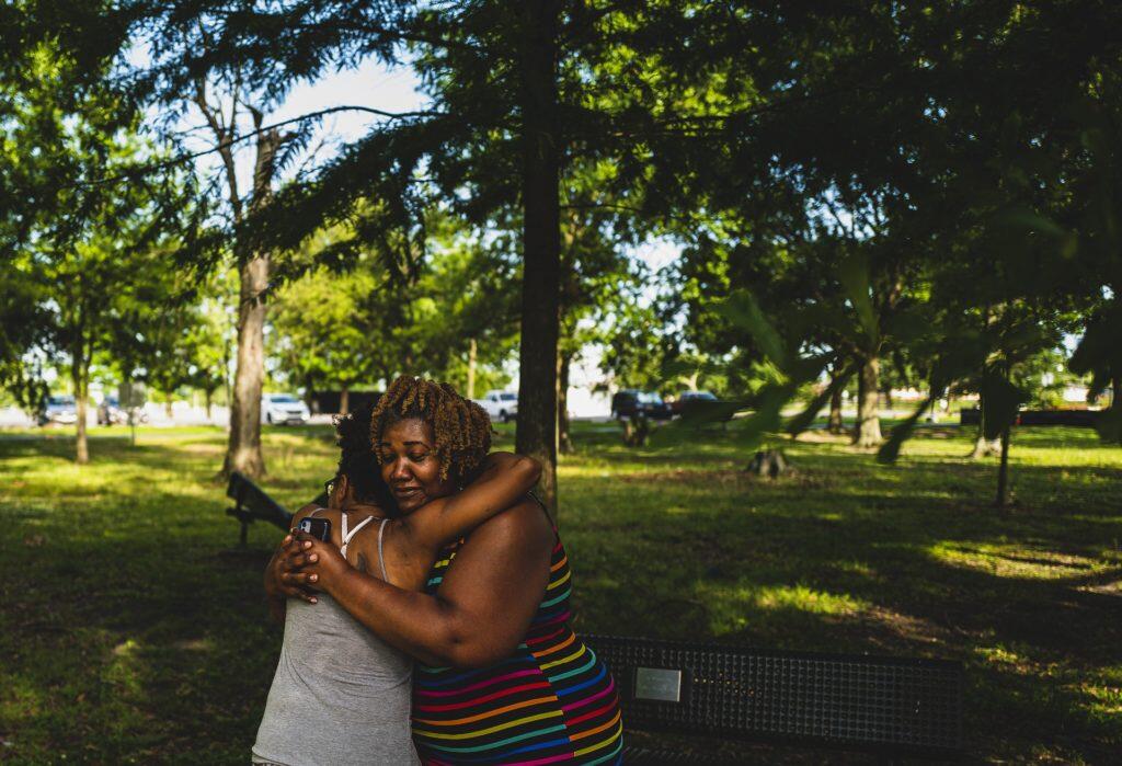 Ursula Newell Davis hugging a woman