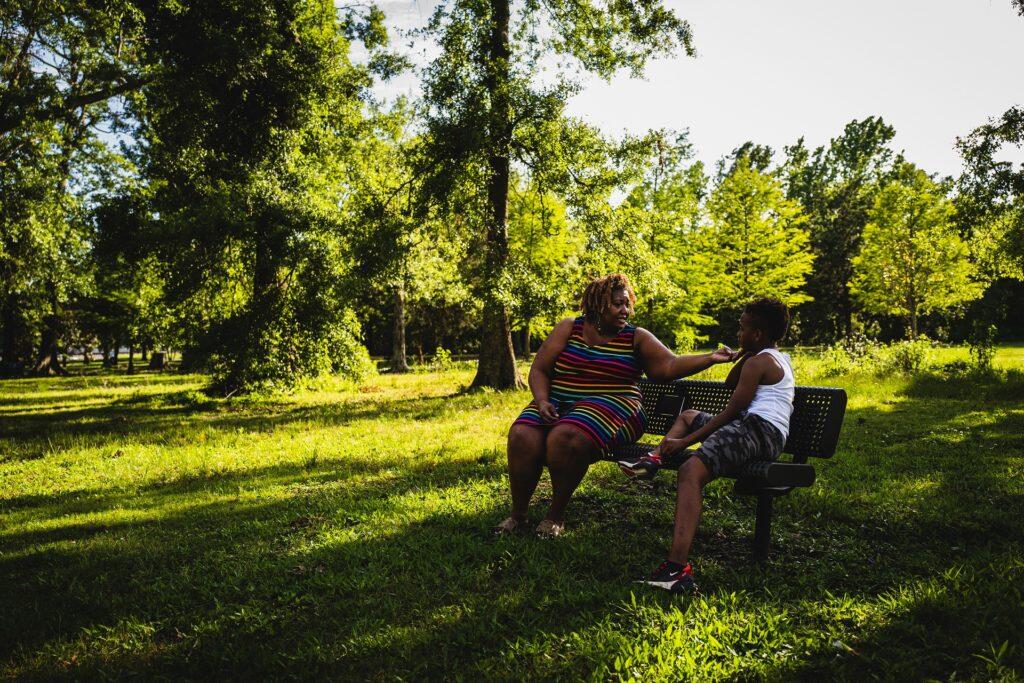 Ursula Newell Davis and a young boy sitting on a bench