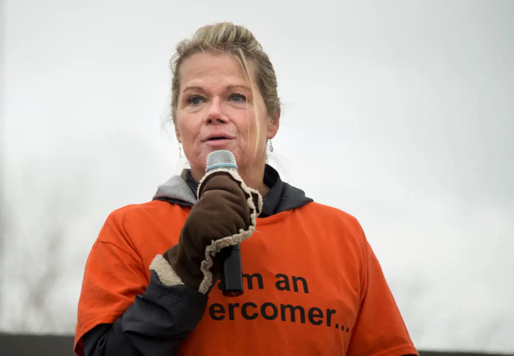 A Prison Fellowship Academy Alumni speaks on a microphone