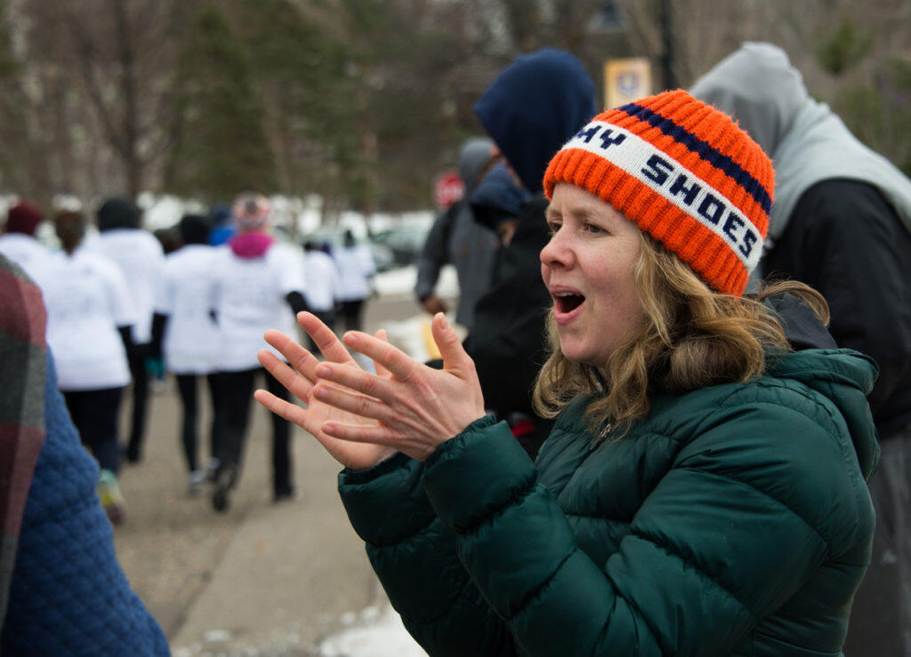 A woman cheers as racers run
