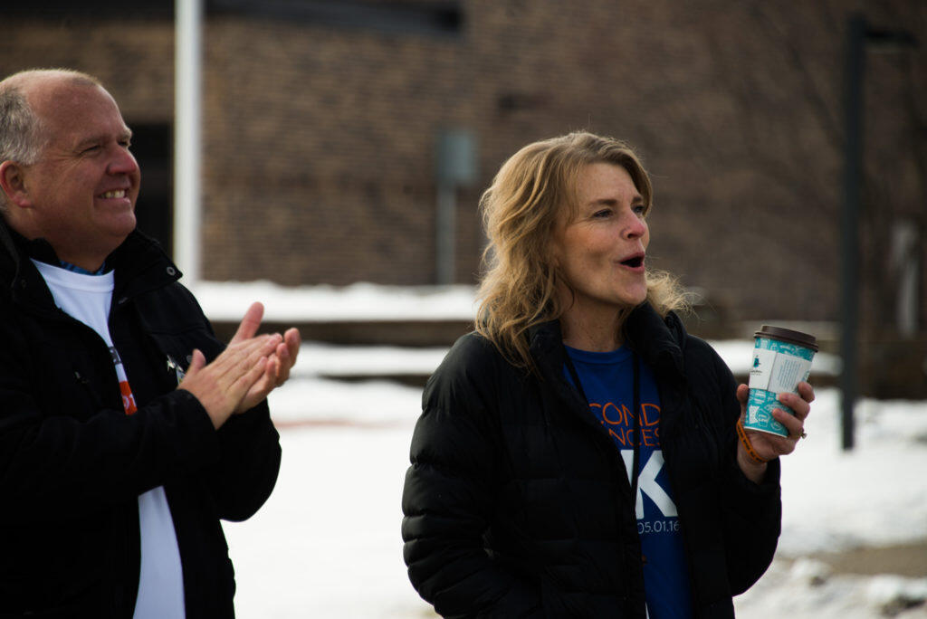 Warden Tracy Beltz and a man cheer as the race goes on