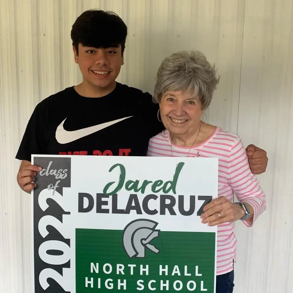 Jared Delacruz posing for a photo with his mentor Mrs. Martha