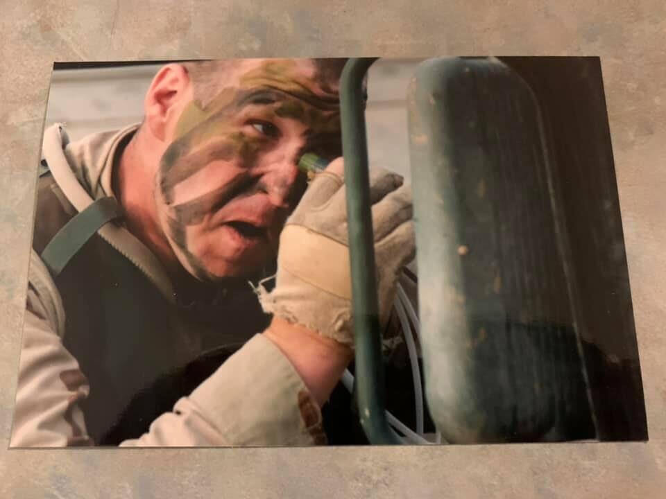 John Brynes in tactical gear and camo face paint