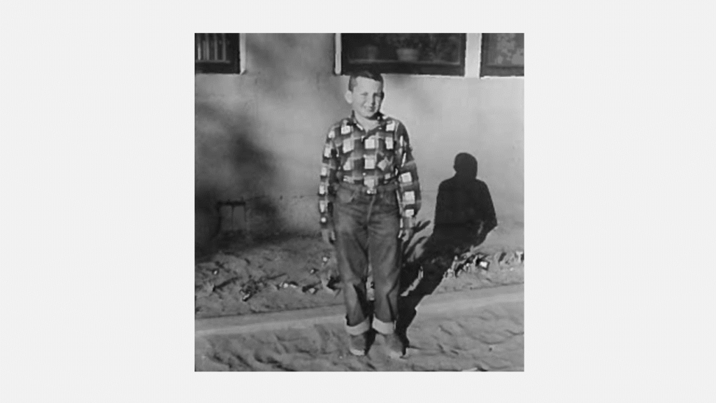 A black and white photo of a young boy