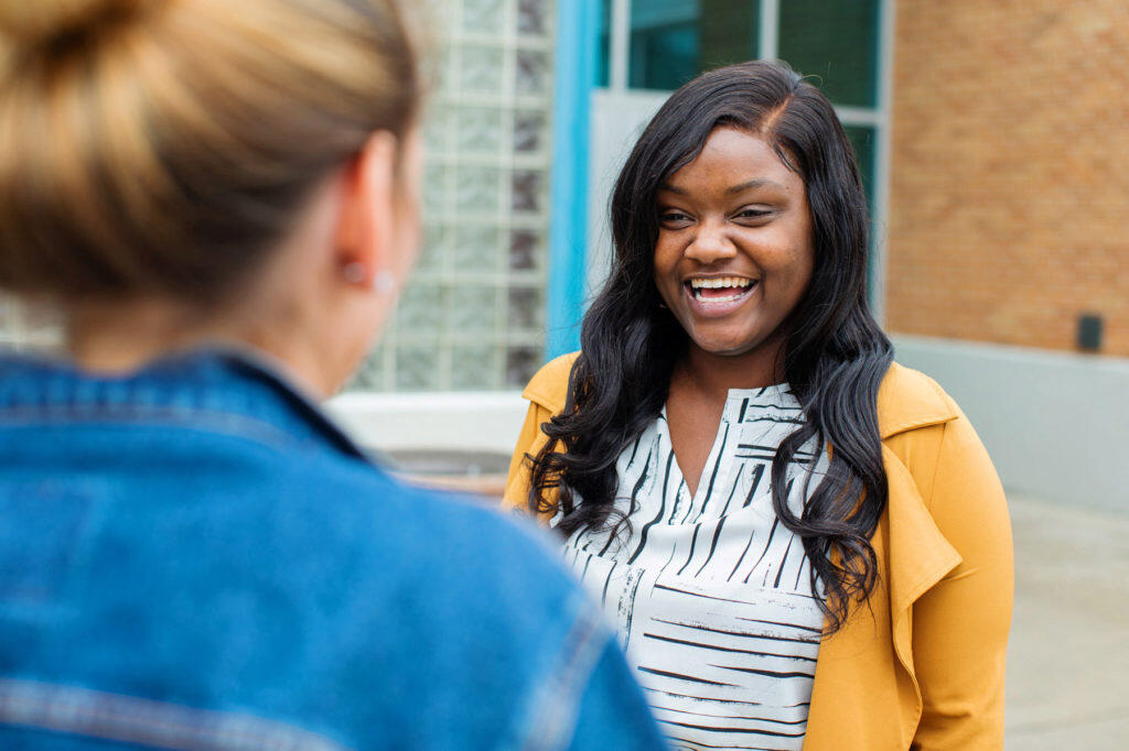 Austiana Jackson smiling while talking to another person