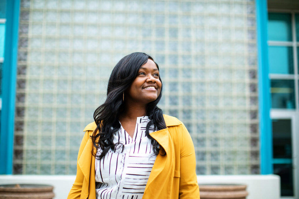 Austiana Jackson posing looking off into the distance in front of a building