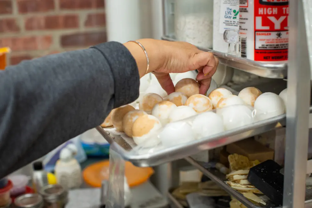 La Shonda fills a tray with soaps