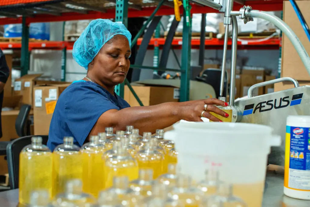 A woman filling bottles with soap