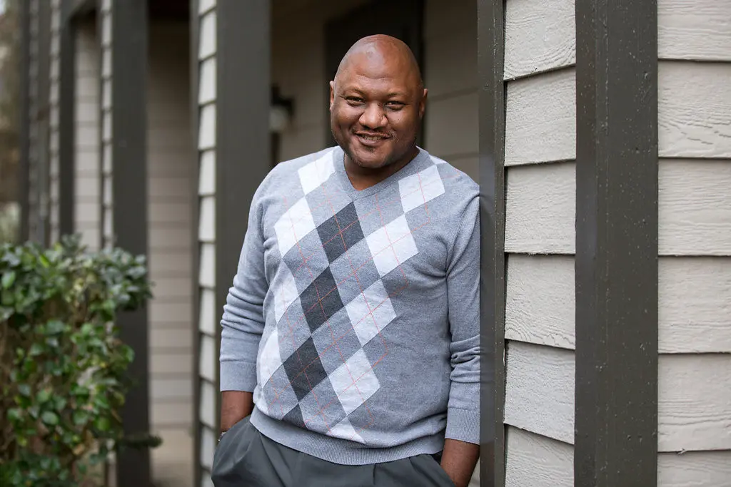 EJ, Shelters to Shutters participant, posing for a photo outside
