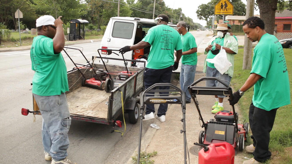 Miles of Freedom members unloading lawn movers