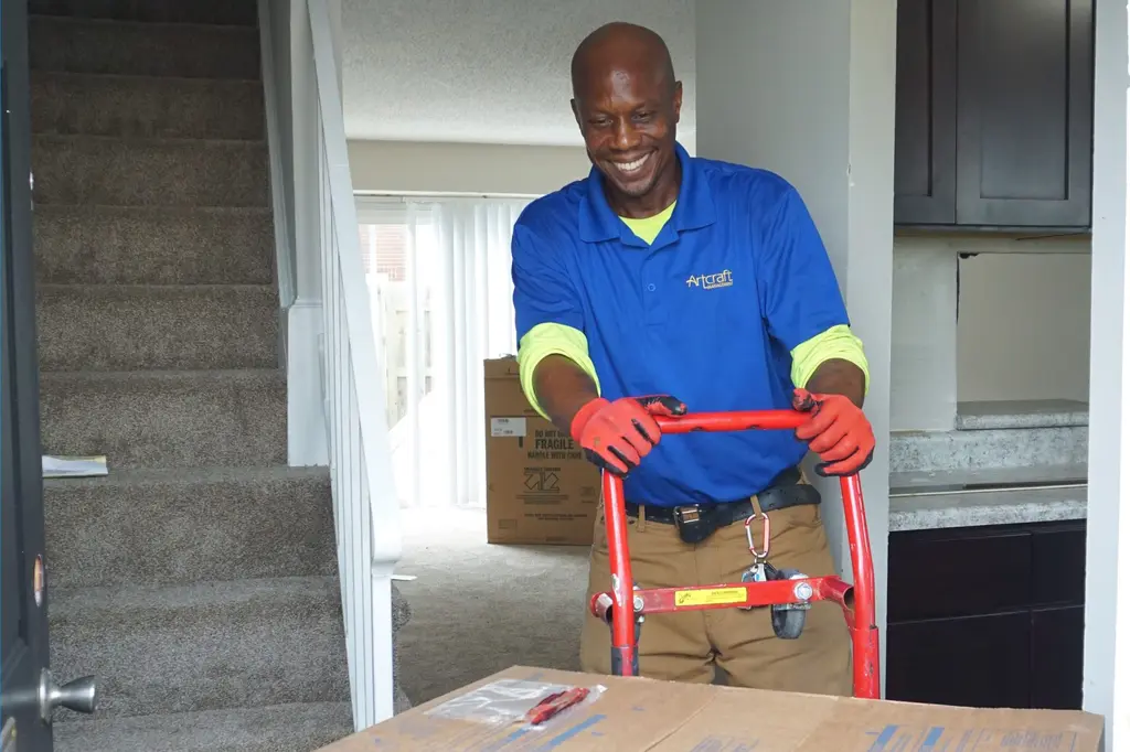 Vonley, Shelters to Shutter participant, moves boxes on a dolly