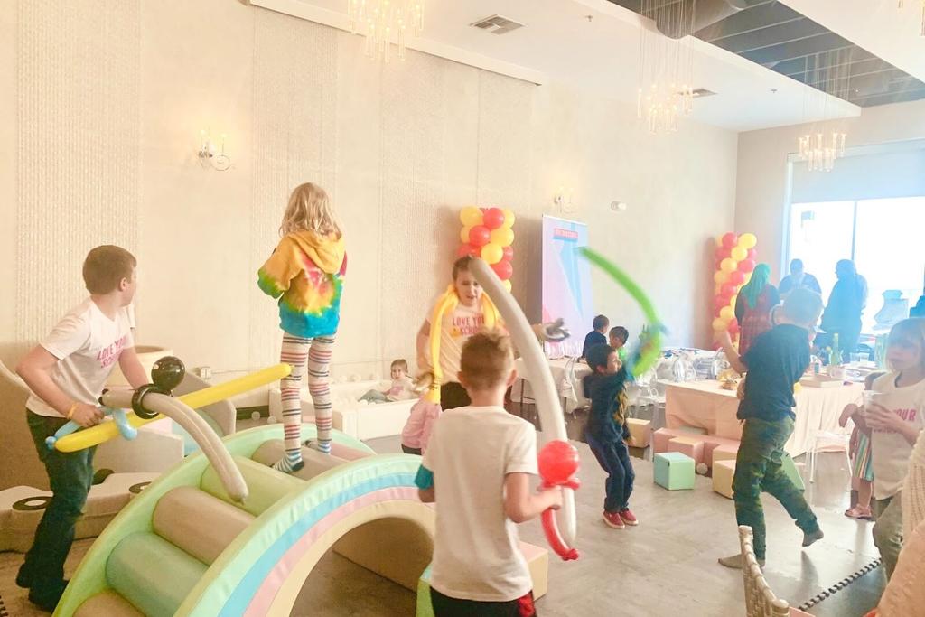 Children playing with balloon swords