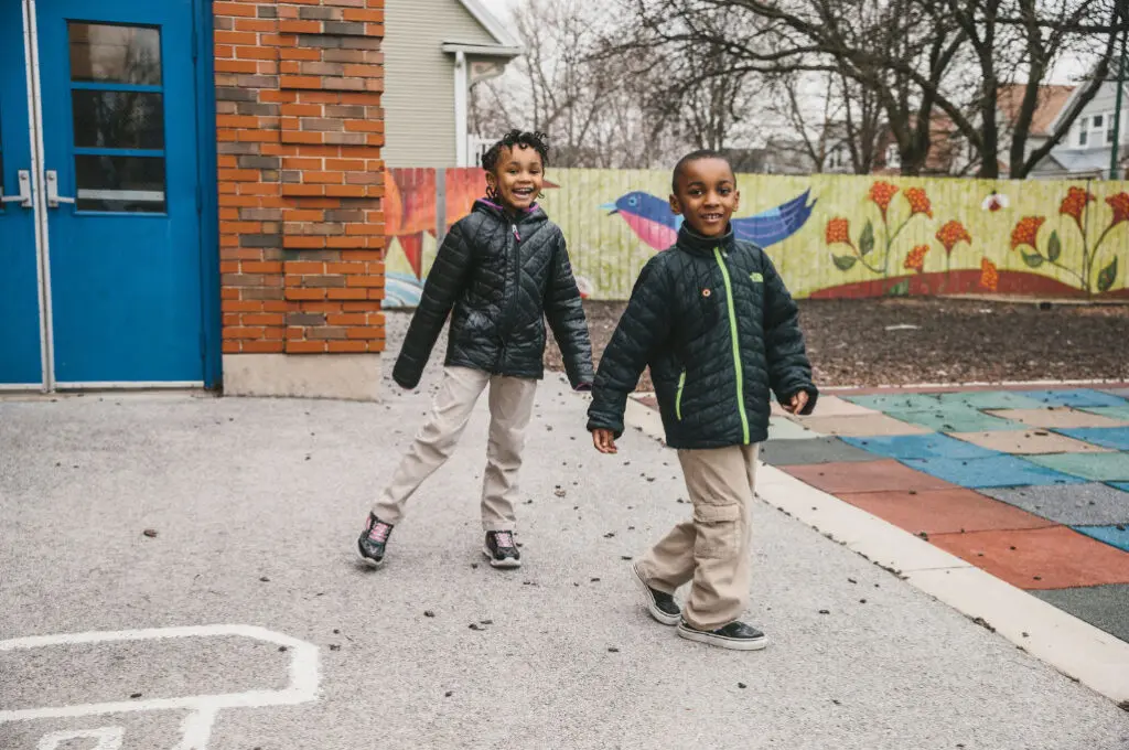 two kids smiling outside