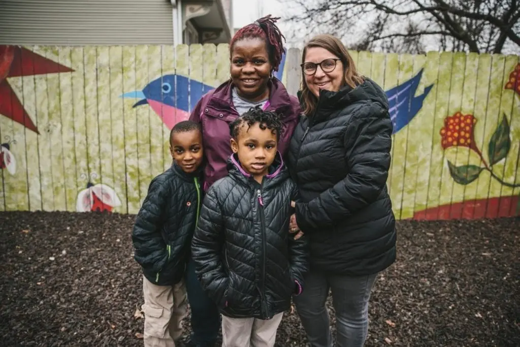 Two women pose with two children for a photo