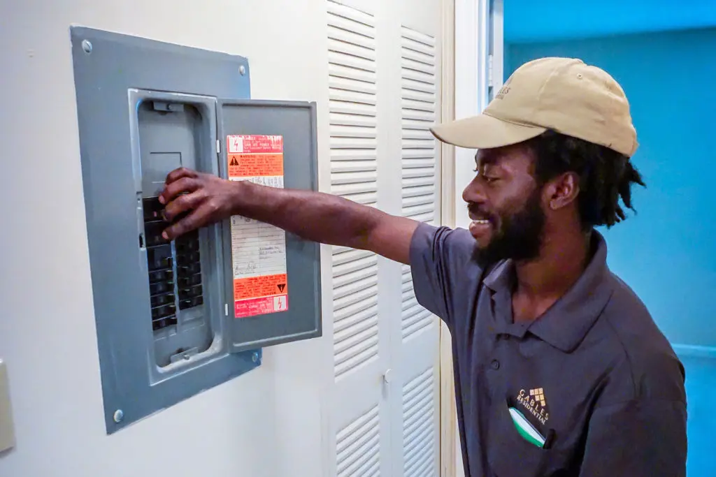 A man working on a breaker box